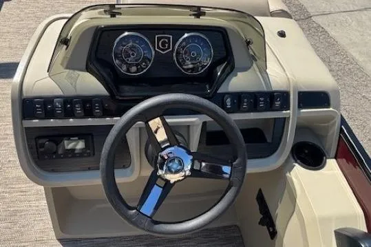 Slide: The Image of 2024 Godfrey SWEETWATER 2286 SFL boat dashboard with steering wheel and instrument panel. - 19