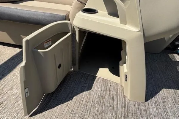 Slide: The Image of Open storage compartment on 2024 Godfrey SWEETWATER 2286 SFL boat, featuring beige interior. - 21