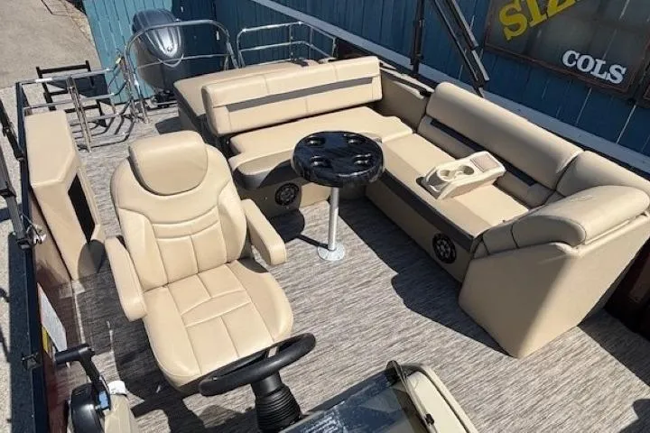 Slide: The Image of 2024 Godfrey SWEETWATER 2286 SFL pontoon boat interior with beige seating and steering console. - 23