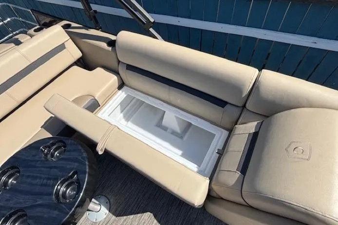 Slide: The Image of 2024 Godfrey SWEETWATER 2286 SFL boat interior with beige seating and built-in storage. - 25