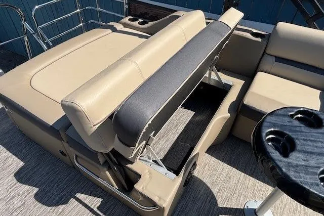 Slide: The Image of 2024 Godfrey SWEETWATER 2286 SFL boat interior with beige seating and storage compartment. - 28