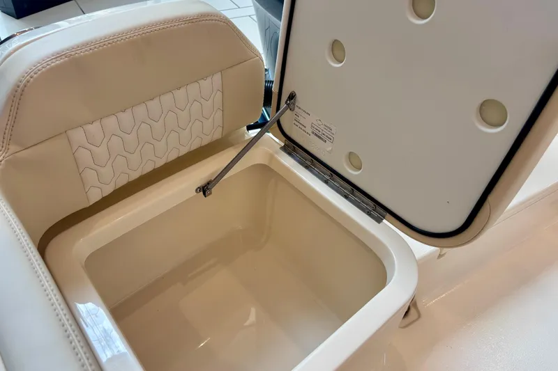 Slide: The Image of Open storage compartment on 2026 Scout 188 Sportfish boat with cushioned seat. - 13