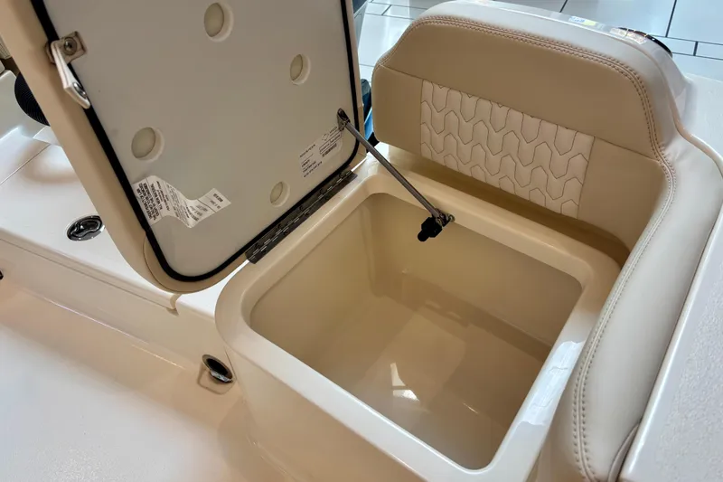 Slide: The Image of Open storage compartment in 2026 Scout 188 Sportfish boat with cushioned seating. - 14