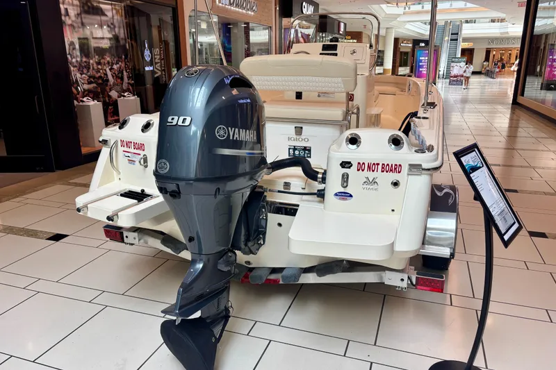 Slide: The Image of 2026 Scout 188 Sportfish boat with Yamaha 90 engine displayed indoors. - 3