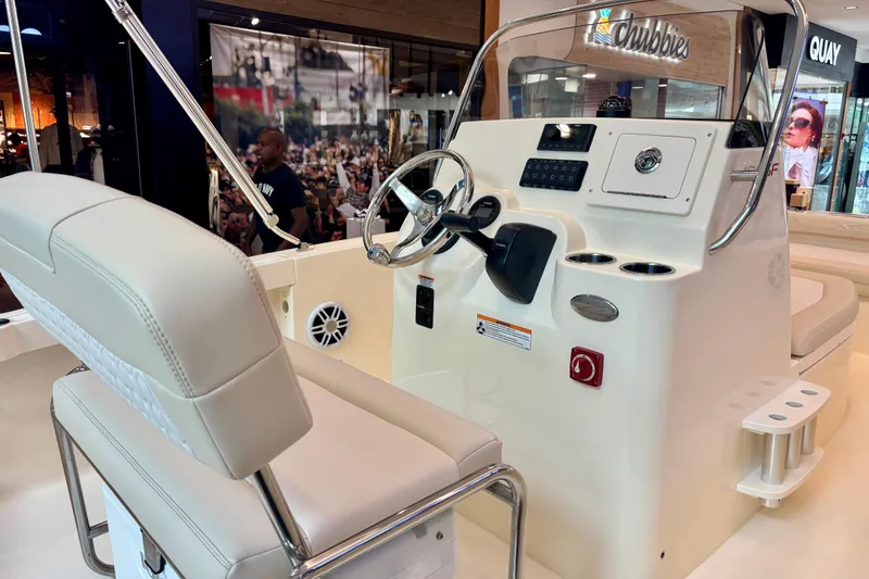 Slide: The Image of 2026 Scout 188 Sportfish boat interior with steering console and seating. - 5