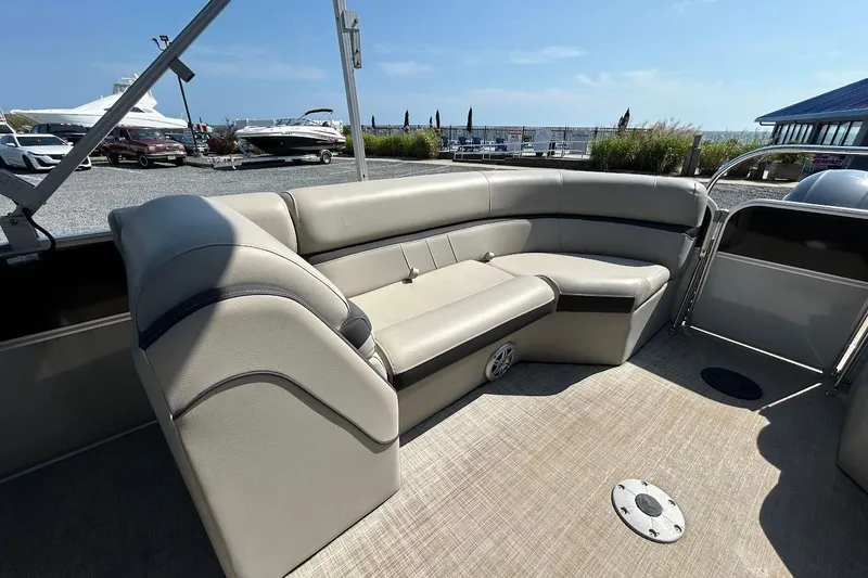 Slide: The Image of 2018 South Bay 224RS pontoon boat interior with beige seating and open deck. - 10
