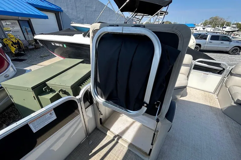 Slide: The Image of 2018 South Bay 224RS pontoon boat interior with seating and storage area. - 11