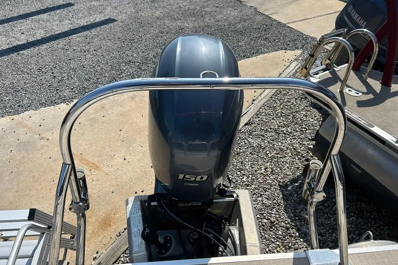 Slide: The Image of 2018 South Bay 224RS boat with Yamaha 150 outboard motor, docked on gravel surface. - 12