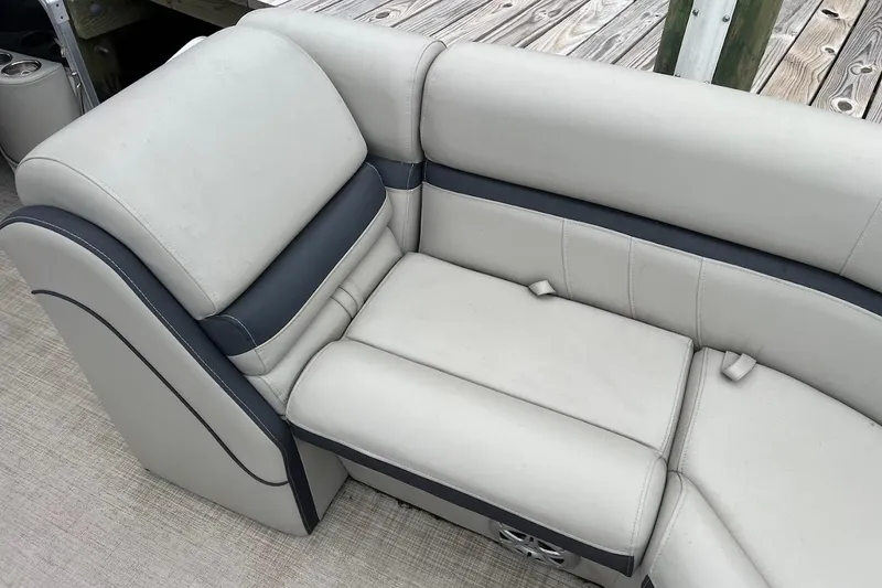 Slide: The Image of 2018 South Bay 224RS boat dashboard with steering wheel and gauges in a parking lot. - 6