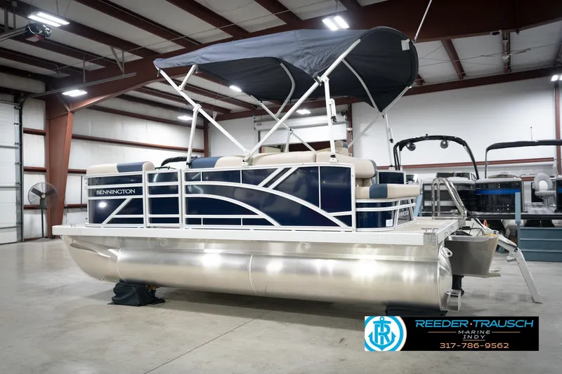 Slide: The Image of 2026 Bennington 168 SLJ pontoon boat in showroom, featuring sleek design and comfortable seating. - 10