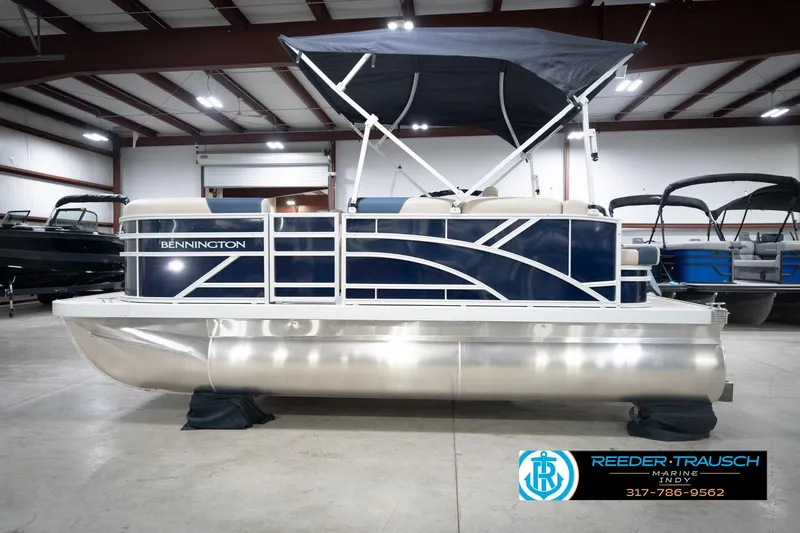 Slide: The Image of 2026 Bennington 168 SLJ pontoon boat in showroom with canopy and sleek design. - 11