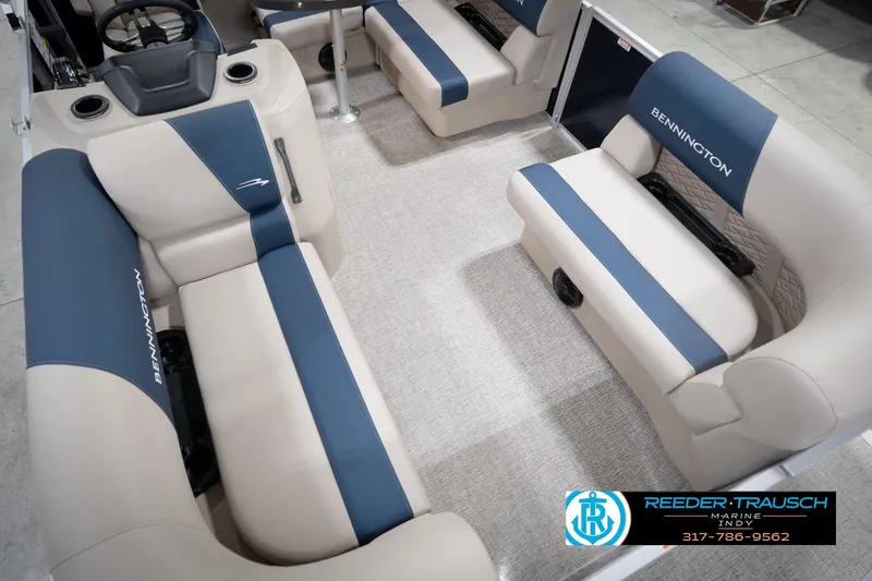 Slide: The Image of 2026 Bennington 168 SLJ boat interior with beige and blue seating, Reeder-Trausch Marine logo. - 13