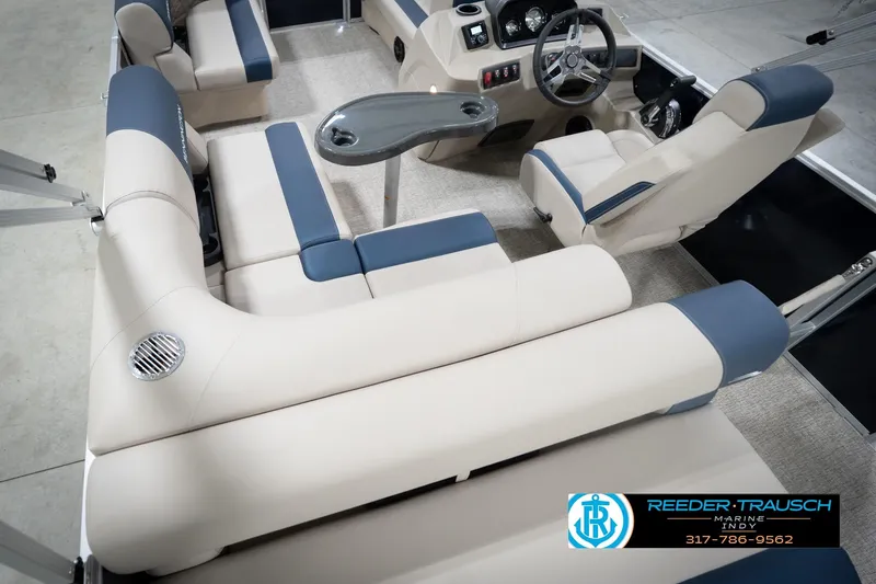 Slide: The Image of 2026 Bennington 168 SLJ boat interior with beige and blue seating, steering console, and table. - 15
