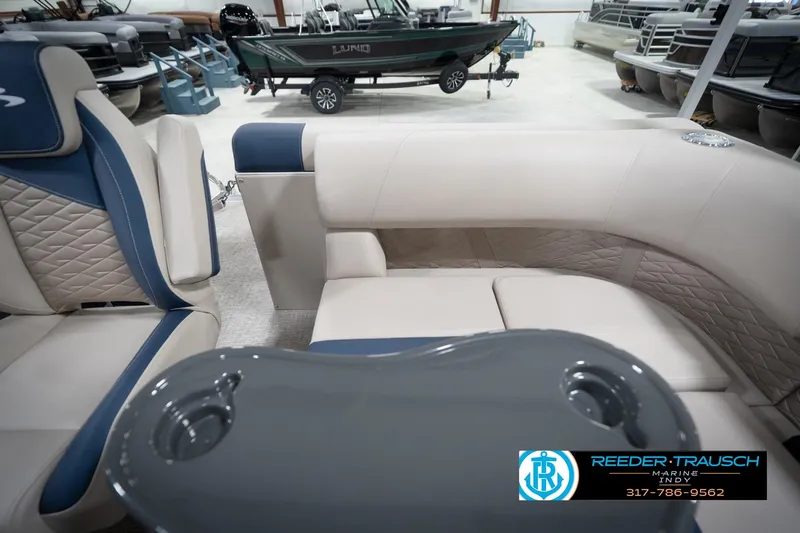 Slide: The Image of 2026 Bennington 168 SLJ boat interior with seating and table, showcased at Reeder-Trausch Marine. - 18
