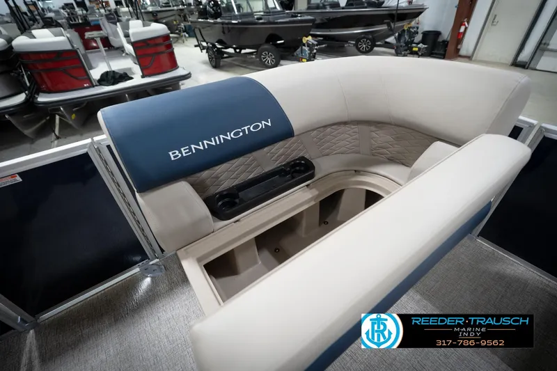 Slide: The Image of 2026 Bennington 168 SLJ boat interior with blue and beige seating in showroom. - 23