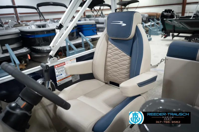 Slide: The Image of 2026 Bennington 168 SLJ boat seat with blue and beige upholstery in showroom. - 27