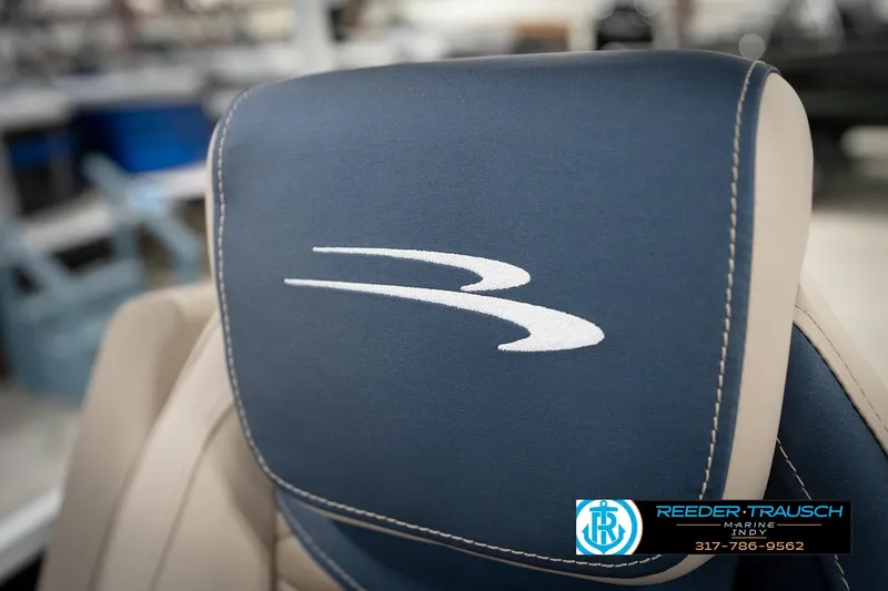 Slide: The Image of 2026 Bennington 168 SLJ boat interior with luxurious seating and steering wheel in a showroom. - 43
