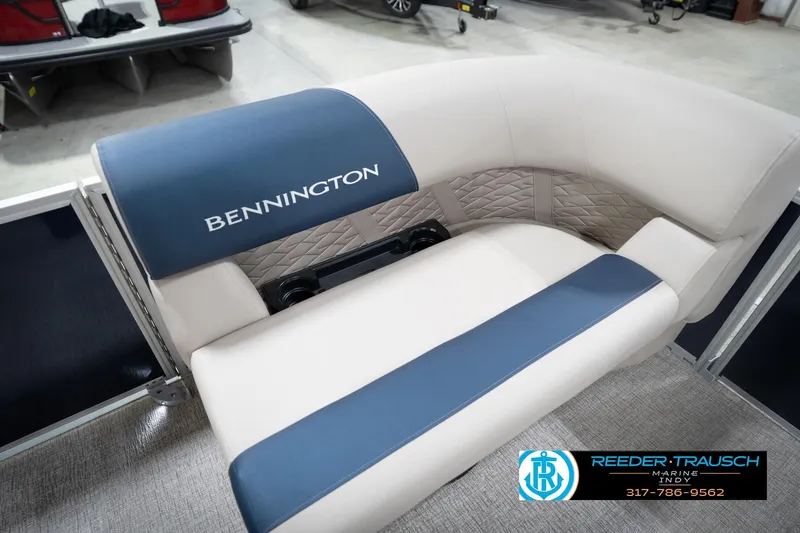 Slide: The Image of 2026 Bennington 168 SLJ boat interior with beige and blue seating, cup holders. - 46