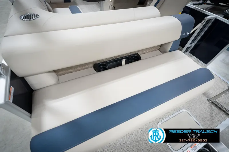 Slide: The Image of 2026 Bennington 168 SLJ boat interior with blue and beige seating, Reeder-Trausch Marine logo. - 48