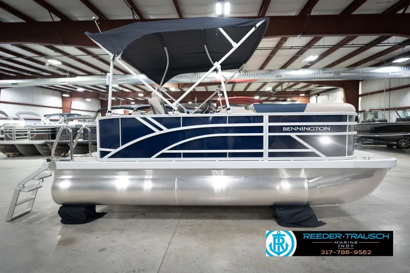 Slide: The Image of 2026 Bennington 168 SLJ pontoon boat in showroom with canopy and sleek design. - 7
