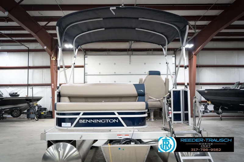 Slide: The Image of 2026 Bennington 168 SLJ pontoon boat with canopy in showroom setting. - 9
