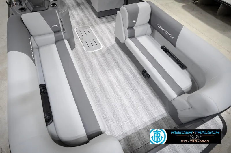Slide: The Image of 2026 Bennington 21 SL boat interior with gray seating and flooring, featuring Reeder-Trausch Marine logo. - 13