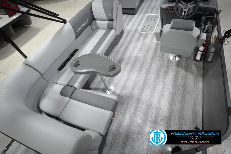 Slide: The Image of 2026 Bennington 21 SL pontoon boat interior with gray seating and steering console. - 14