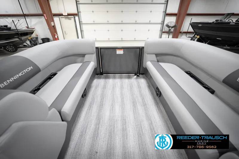 Slide: The Image of 2026 Bennington 21 SL pontoon boat interior with gray seating in showroom. - 21