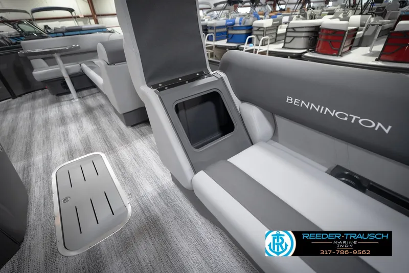 Slide: The Image of 2026 Bennington 21 SL boat interior with gray seating and storage compartments. - 25