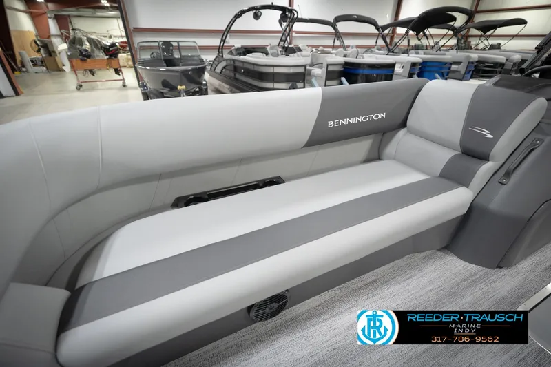Slide: The Image of 2026 Bennington 21 SL boat interior with gray seating in showroom. - 26