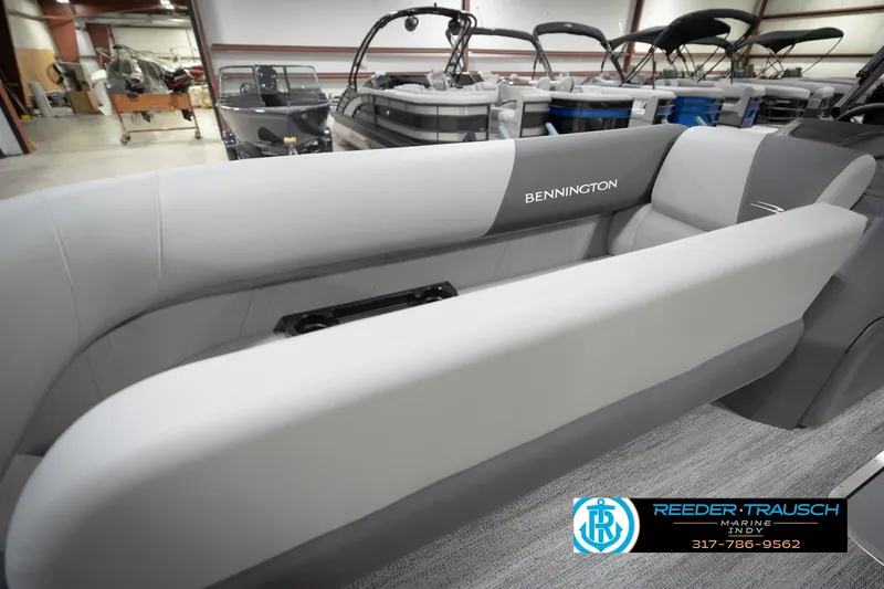 Slide: The Image of 2026 Bennington 21 SL pontoon boat interior with gray seating in showroom. - 27