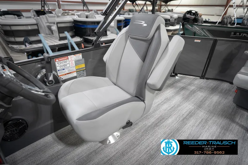 Slide: The Image of 2026 Bennington 21 SL boat interior with gray captain's chair and steering wheel. - 28