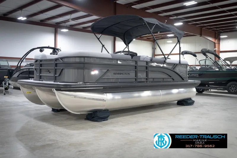 Slide: The Image of 2026 Bennington 21 SL pontoon boat in showroom with canopy and sleek design. - 4