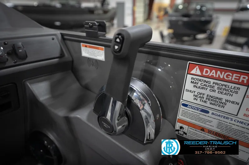 Slide: The Image of Control panel of 2026 Bennington 21 SL boat with safety warnings and throttle lever. - 42