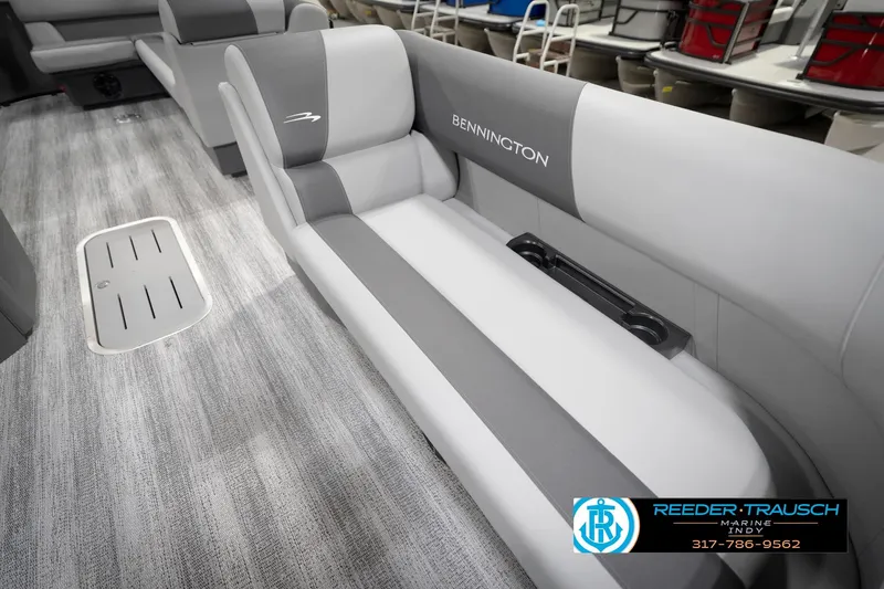 Slide: The Image of 2026 Bennington 21 SL boat interior with gray seating and flooring, featuring cup holders. - 47