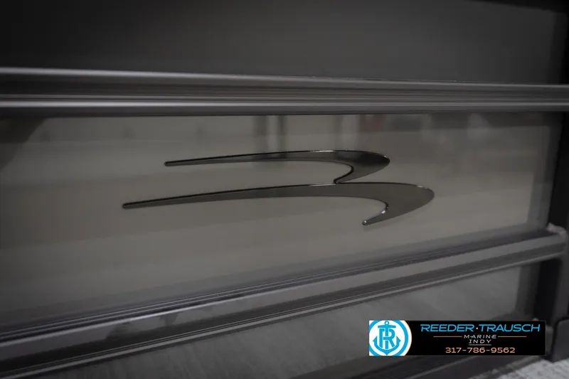 Slide: The Image of 2026 Bennington 21 SL boat detail with sleek metallic design and logo. - 51