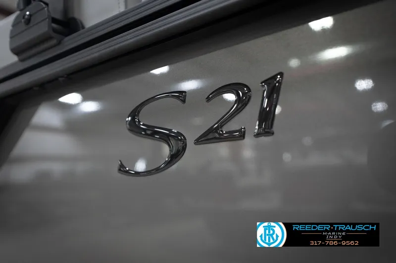 Slide: The Image of 2026 Bennington 21 SL boat with "S21" emblem, Reeder Trausch Marine logo visible. - 53