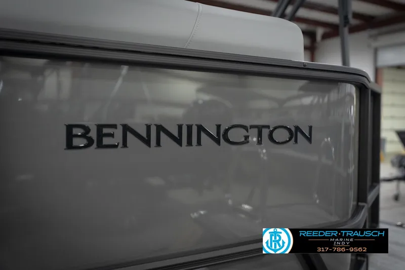 Slide: The Image of 2026 Bennington 21 SL boat with logo, displayed at Reeder-Trausch Marine showroom. - 54