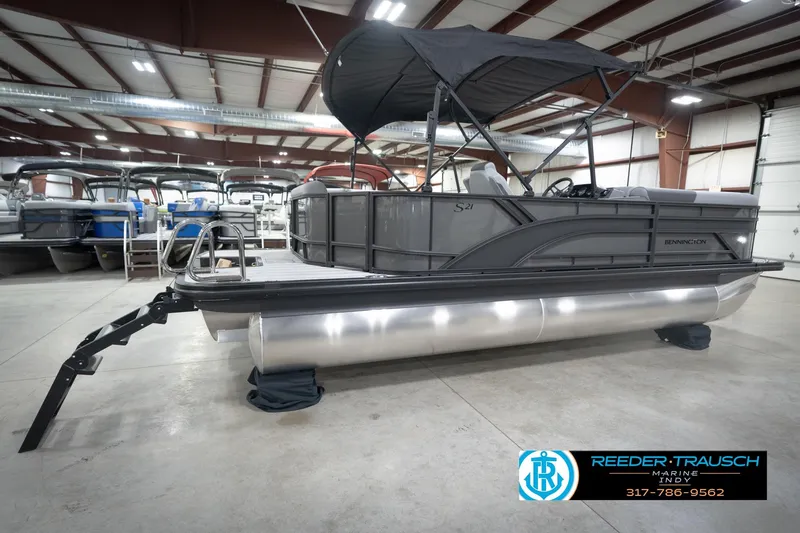 Slide: The Image of 2026 Bennington 21 SL pontoon boat in showroom with canopy and sleek design. - 8