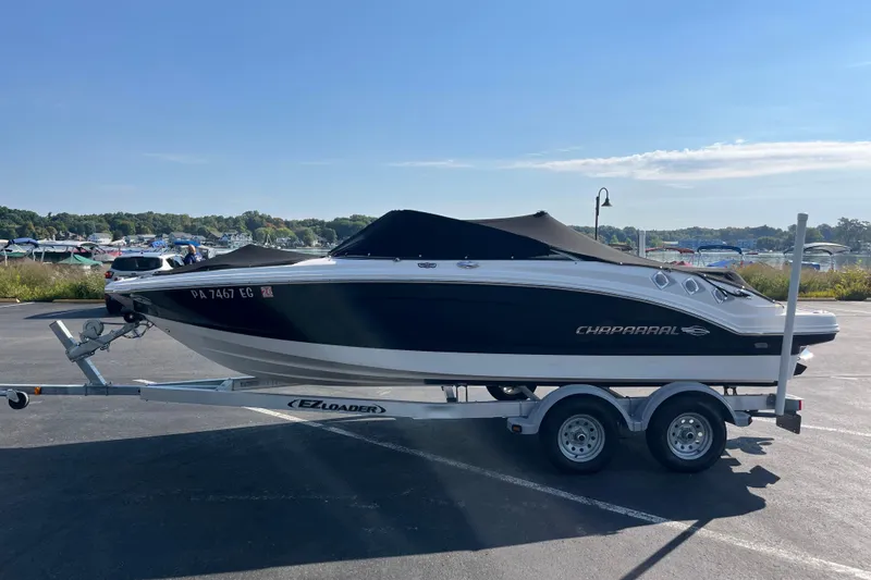 The Image of 2013 Chaparral 206 SSi boat on trailer in sunny parking lot. - 1