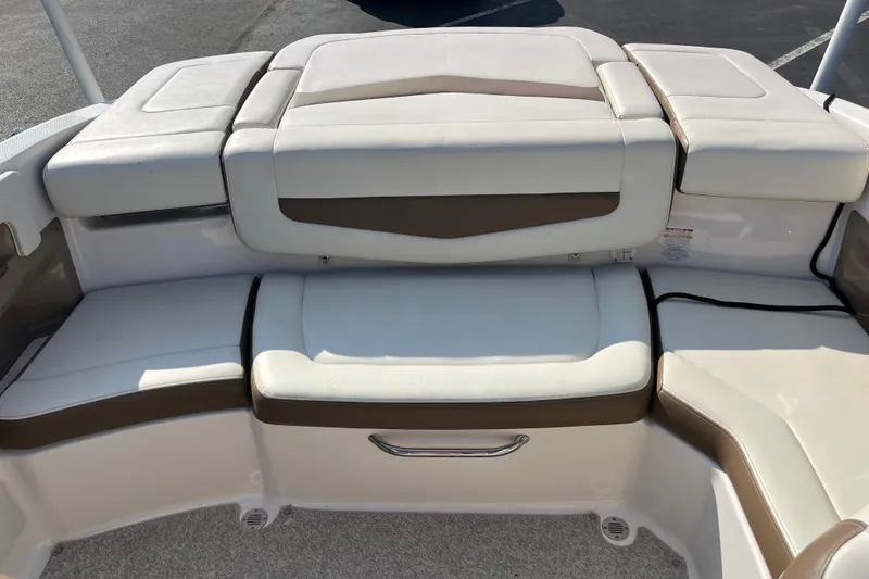 Slide: The Image of 2013 Chaparral 206 SSi boat interior with white and brown cushioned seating. - 10