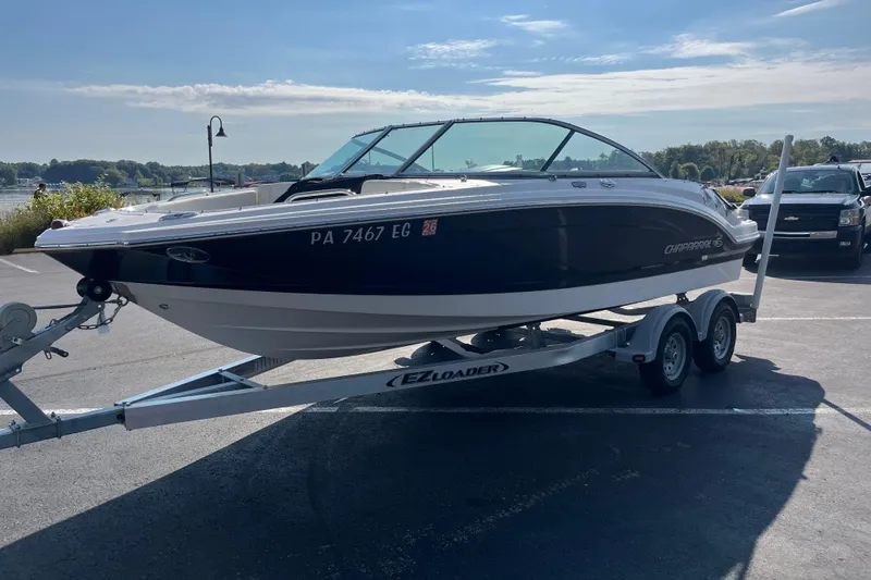 Slide: The Image of 2013 Chaparral 206 SSi boat on trailer in parking lot, sunny day. - 2