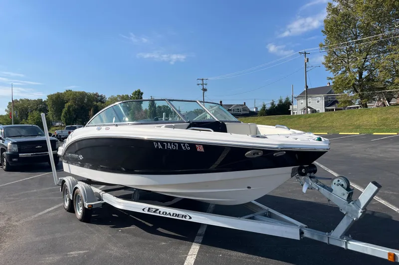 Slide: The Image of 2013 Chaparral 206 SSi boat on trailer in parking lot, clear sky background. - 7