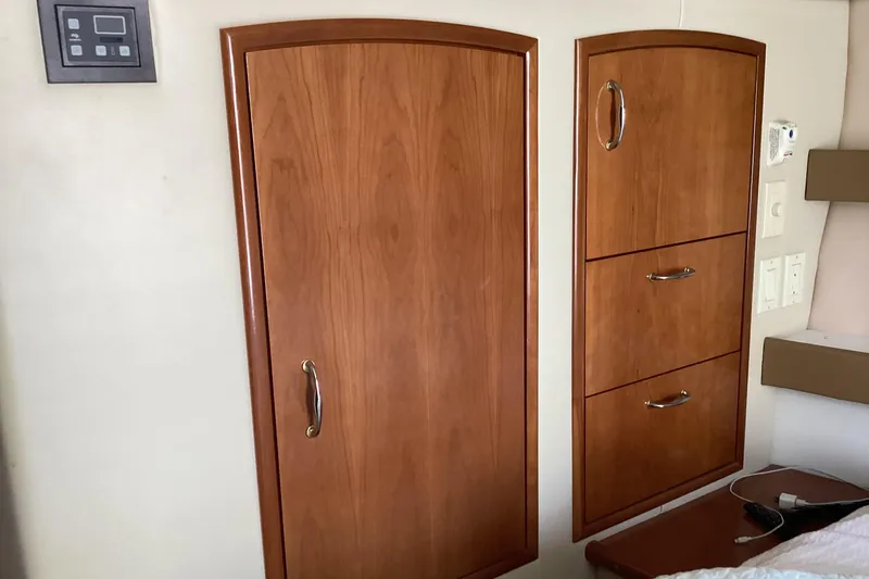 Slide: The Image of 2005 Carver 41 Cockpit Motor Yacht interior with wooden cabinetry and control panel. - 20