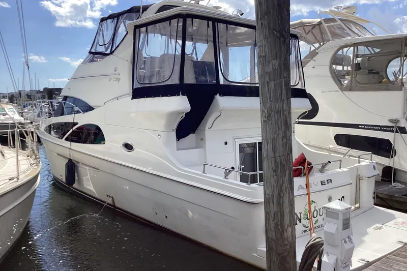 Slide: The Image of 2005 Carver 41 Cockpit Motor Yacht docked at marina, featuring spacious design and elegant lines. - 21