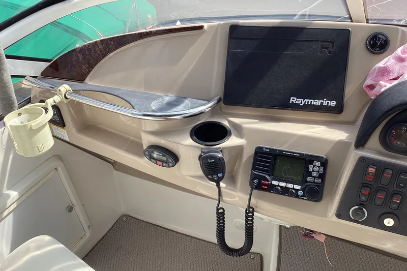 Slide: The Image of 2005 Carver 41 Cockpit Motor Yacht helm with Raymarine navigation and communication equipment. - 26
