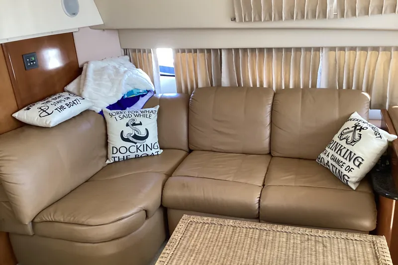 Slide: The Image of Interior of 2005 Carver 41 Cockpit Motor Yacht with leather sofa and nautical-themed pillows. - 38