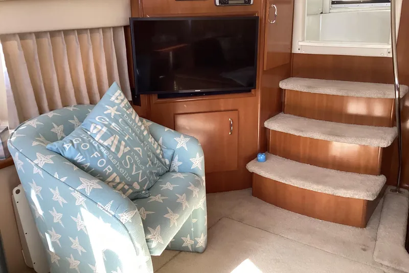 Slide: The Image of Interior of 2005 Carver 41 Cockpit Motor Yacht with cozy seating and TV. - 39