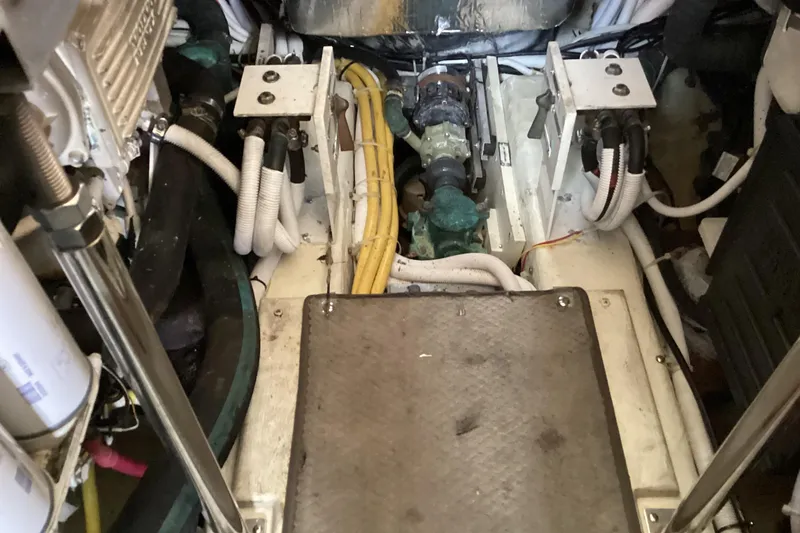 Slide: The Image of Engine room of 2005 Carver 41 Cockpit Motor Yacht with visible wiring and components. - 48