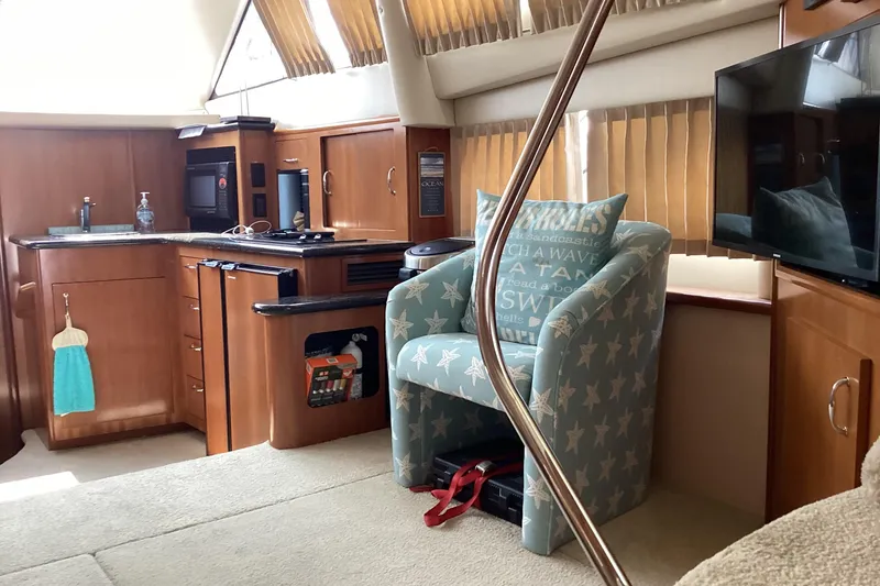 Slide: The Image of Interior of 2005 Carver 41 Cockpit Motor Yacht with kitchen and seating area. - 13